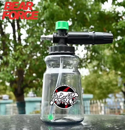 Clear foam cannon with black and green nozzle on a blurred outdoor background with 'Bear Force' branding.